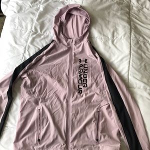 Medium under armor wind breaker. Pink color with black stripes on the sleeves.